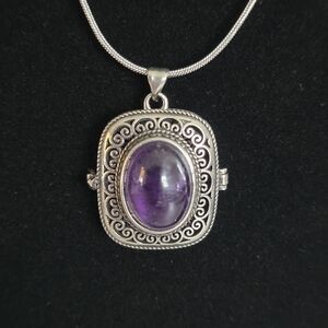 Intricate Amethyst Locket Necklace with chain.